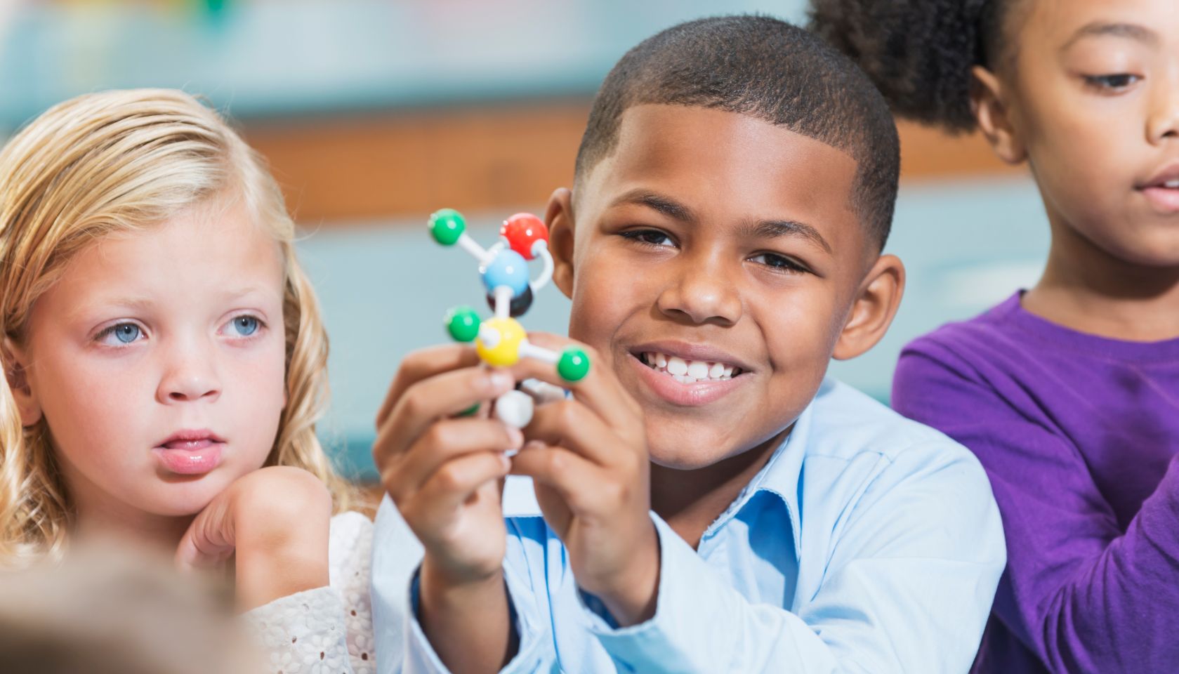 African American boy and friends in science class
