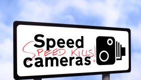 Speed camera sign with graffiti