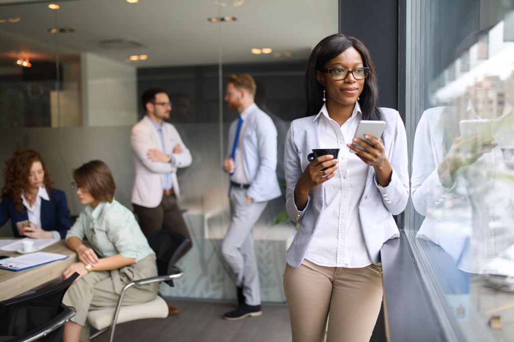 Young businesswoman using mobile in the office.