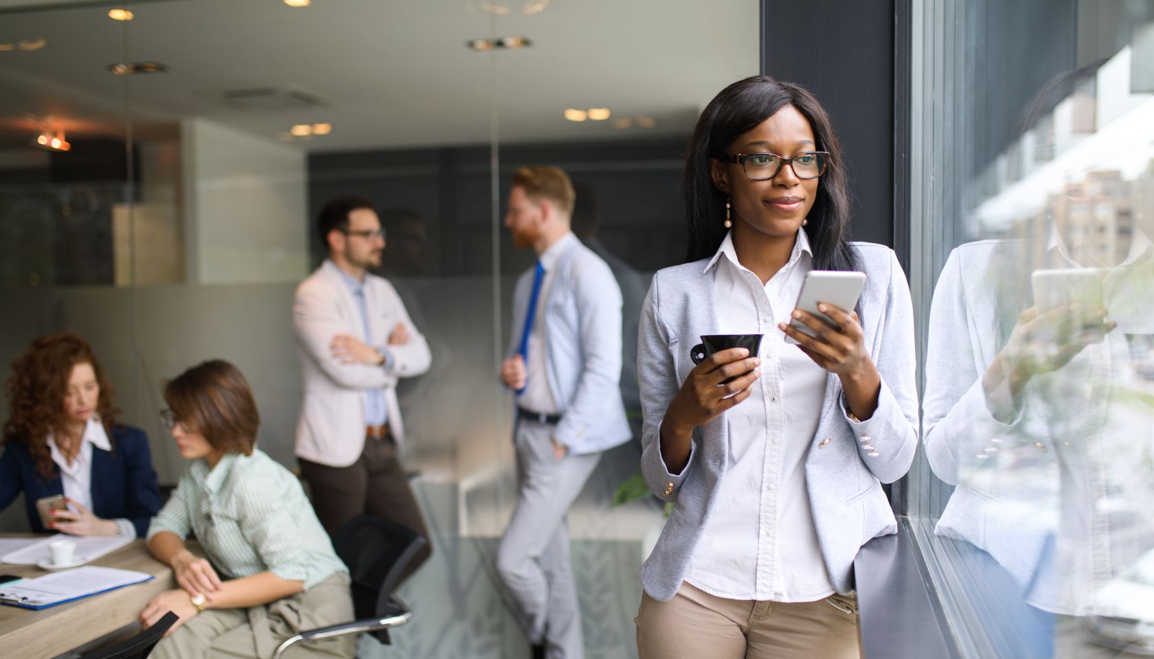 Young businesswoman using mobile in the office.