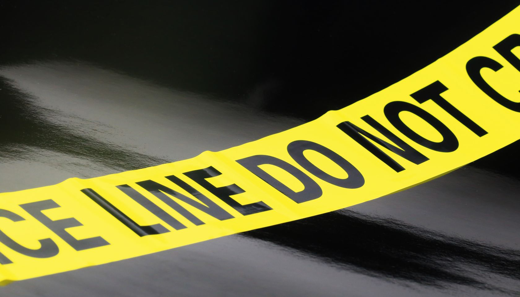Yellow Caution Tape on a black background