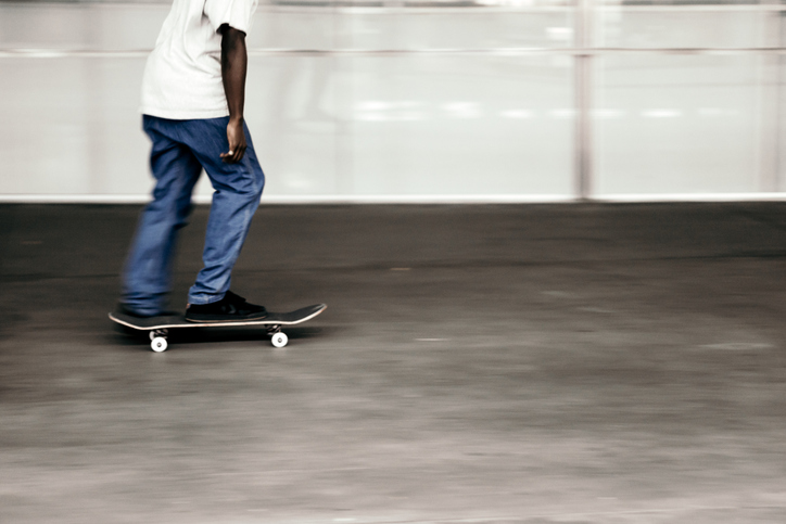 Low Section Of Man Skateboarding In Park