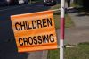 'Children Crossing' traffic flag displayed beside a road