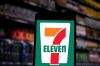 In this photo illustration the 7-Eleven logo seen displayed...