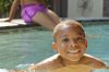 African American boy swimming in swimming pool