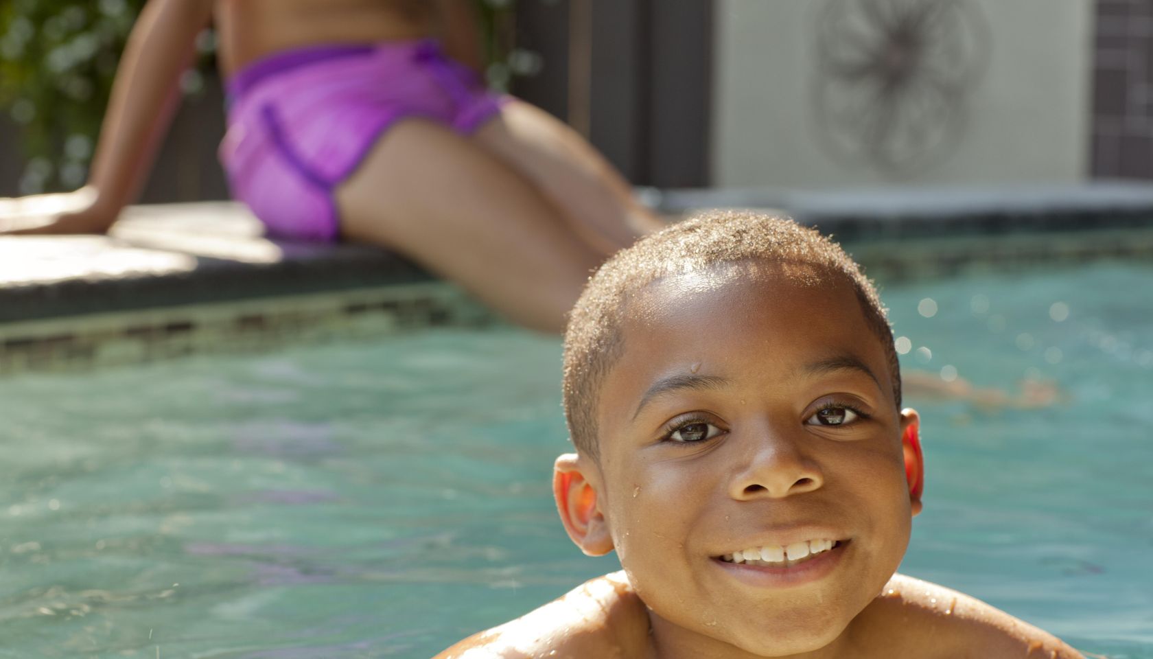 African American boy swimming in swimming pool