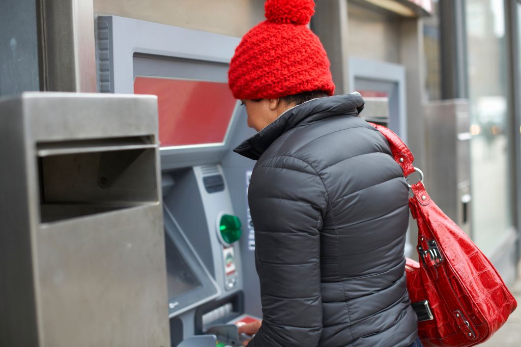Woman using cash machine