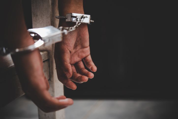Close-Up Of Man Wearing Handcuffs