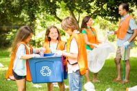 Volunteers: Family cleans up their community park. Recycling bin.