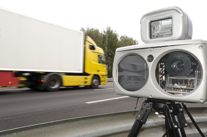 Speed Camera Against Blurred Motion Of Truck On Road
