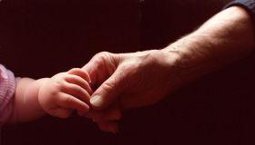 Generic baby holding an elderly persons hand, 1 November 2000. AFR Picture by