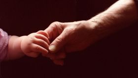 Generic baby holding an elderly persons hand, 1 November 2000. AFR Picture by