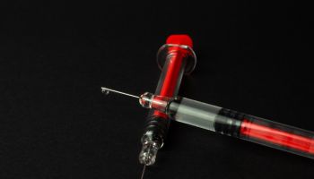 Two syringes on a black background
