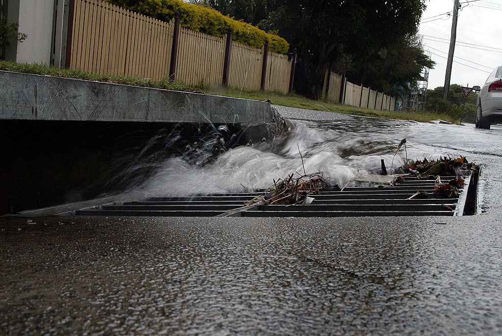 Rain water gushing down a street drain after a downpour, 31 March 2006. AFR Pi