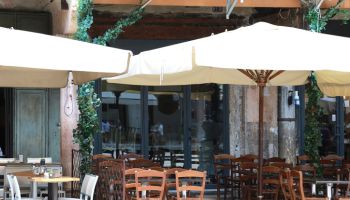 Empty outdoor tables of a Pizzeria - Osteria in Verona
