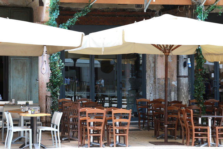 Empty outdoor tables of a Pizzeria - Osteria in Verona