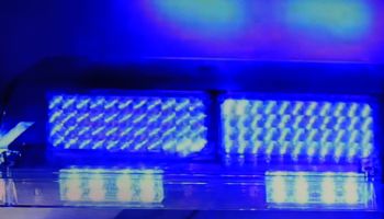 Bright blue colored police car lights flashing