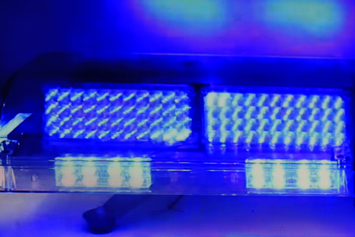 Bright blue colored police car lights flashing