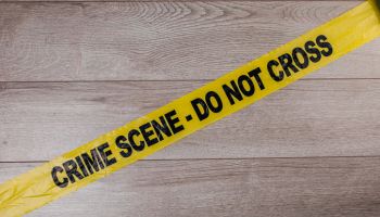 Crime scene tape on wooden background