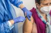 Woman receives a dose of the COVID19 Vaccine at Fira...