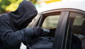 Car theft - thief trying to break into the vehicle.