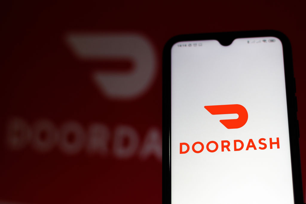 In this photo illustration the DoorDash logo seen displayed...