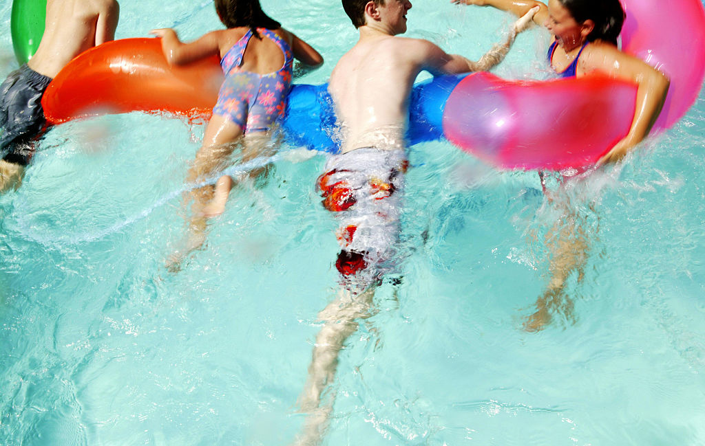 Children swim in a backyard pool, 16 January 2005. AFR Picture by ANDREW QUILTY