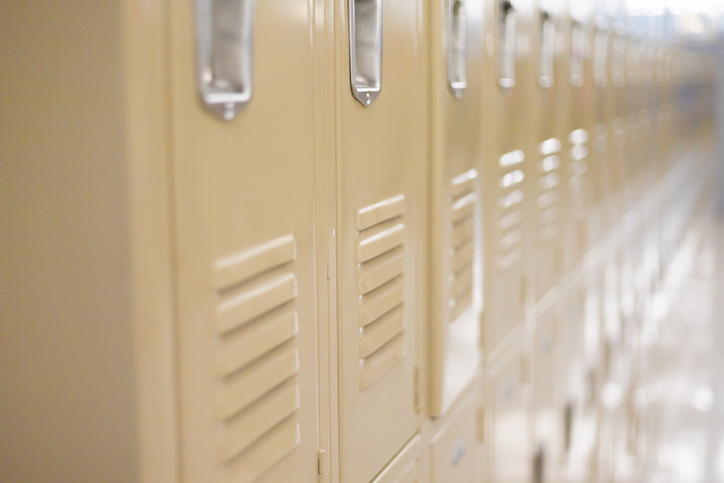 diminishing perspective of row of traditional metal school lockers