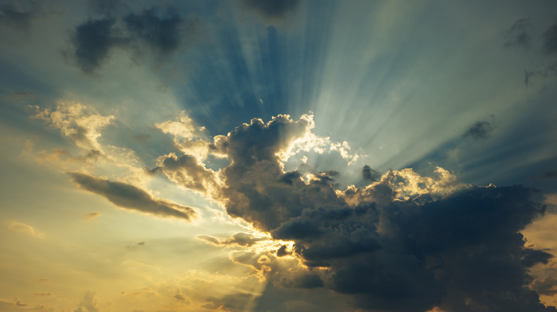 Sunlight Streaming Through Clouds at Sunset
