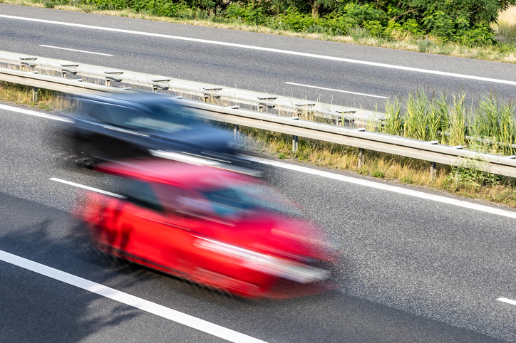 Two very fast cars on a country road