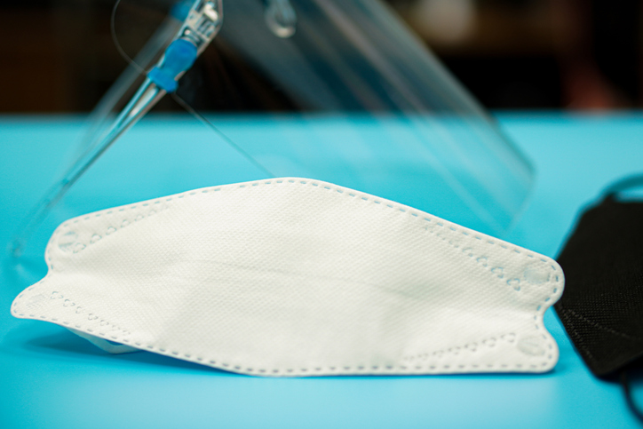 Medical mask and face shield prepared on healthcare work table